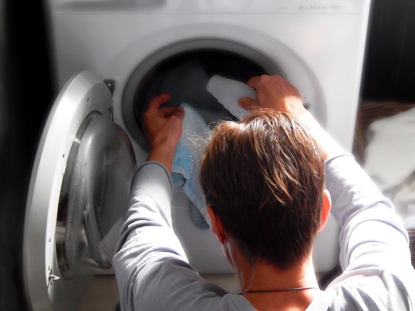 man loading washing machine