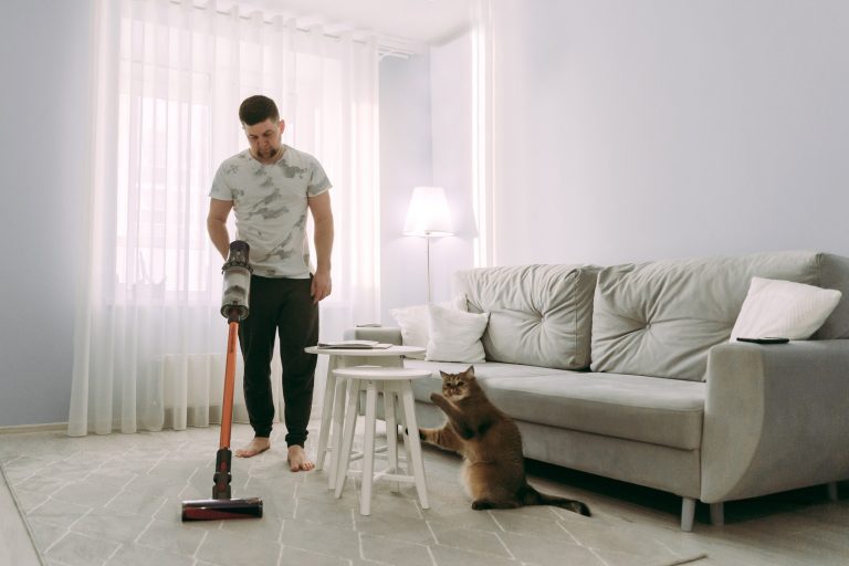 Man vacuuming in living room