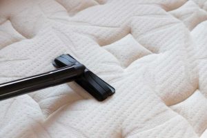 Vacuuming the mattress