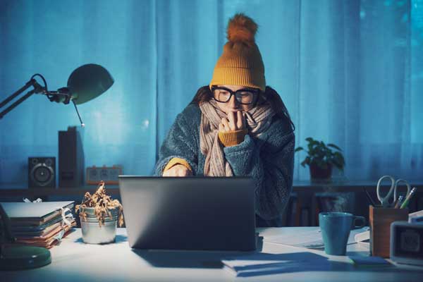 Woman working in cold office